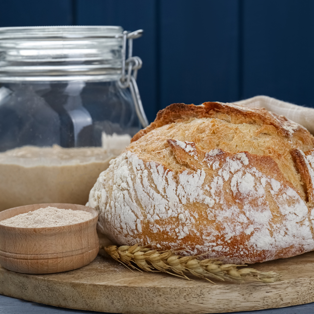 photo of sourdough bread and starter on cutting board